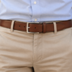 Ceinture en cuir marron portée avec un chino beige et une chemise bleu clair